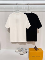 Short-sleeve T-shirts in white and black, hanging on hangers