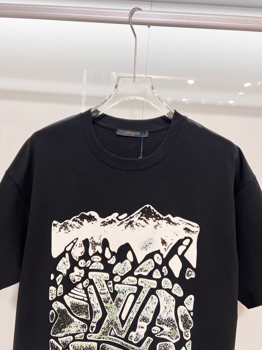 Louis Vuitton black T-shirt close-up of front logo graphic and crew neckline
