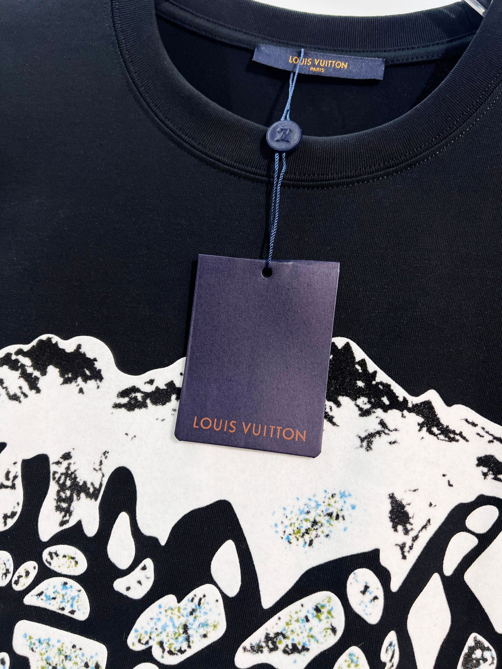 Louis Vuitton black T-shirt with hanging tag and partial white logo graphic