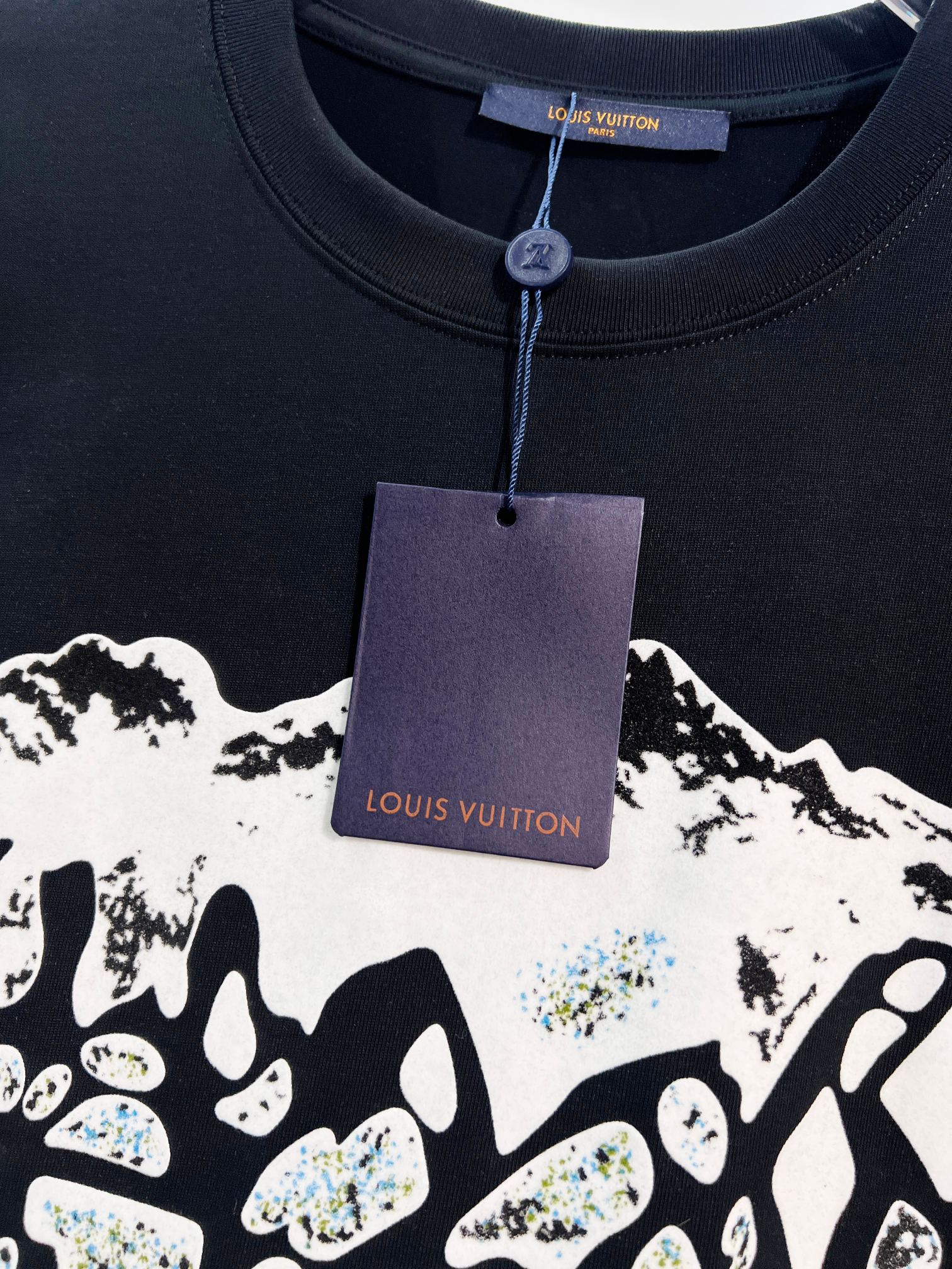 Louis Vuitton black T-shirt with hanging tag and partial white logo graphic