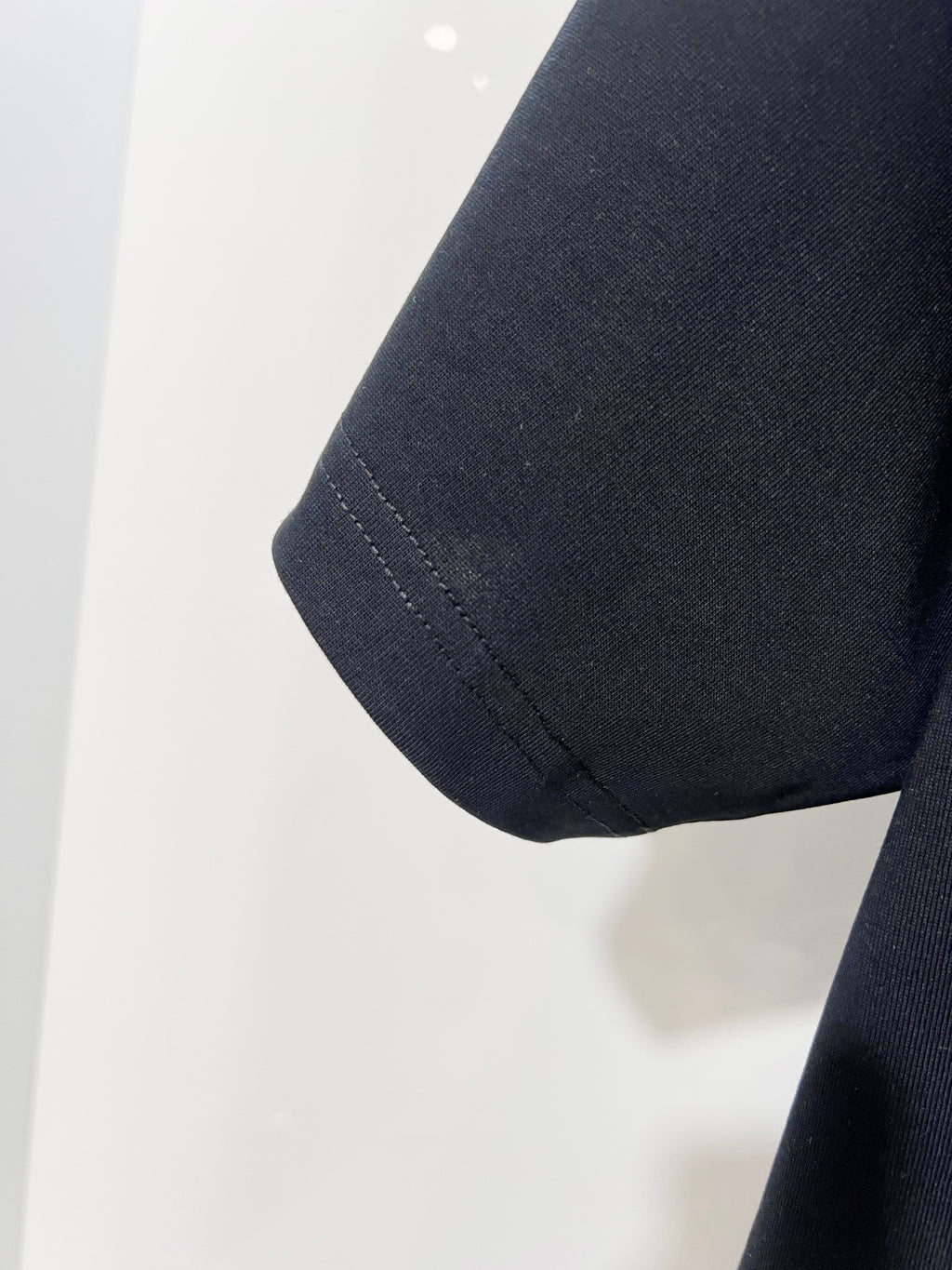 Louis Vuitton black T-shirt sleeve hem close-up