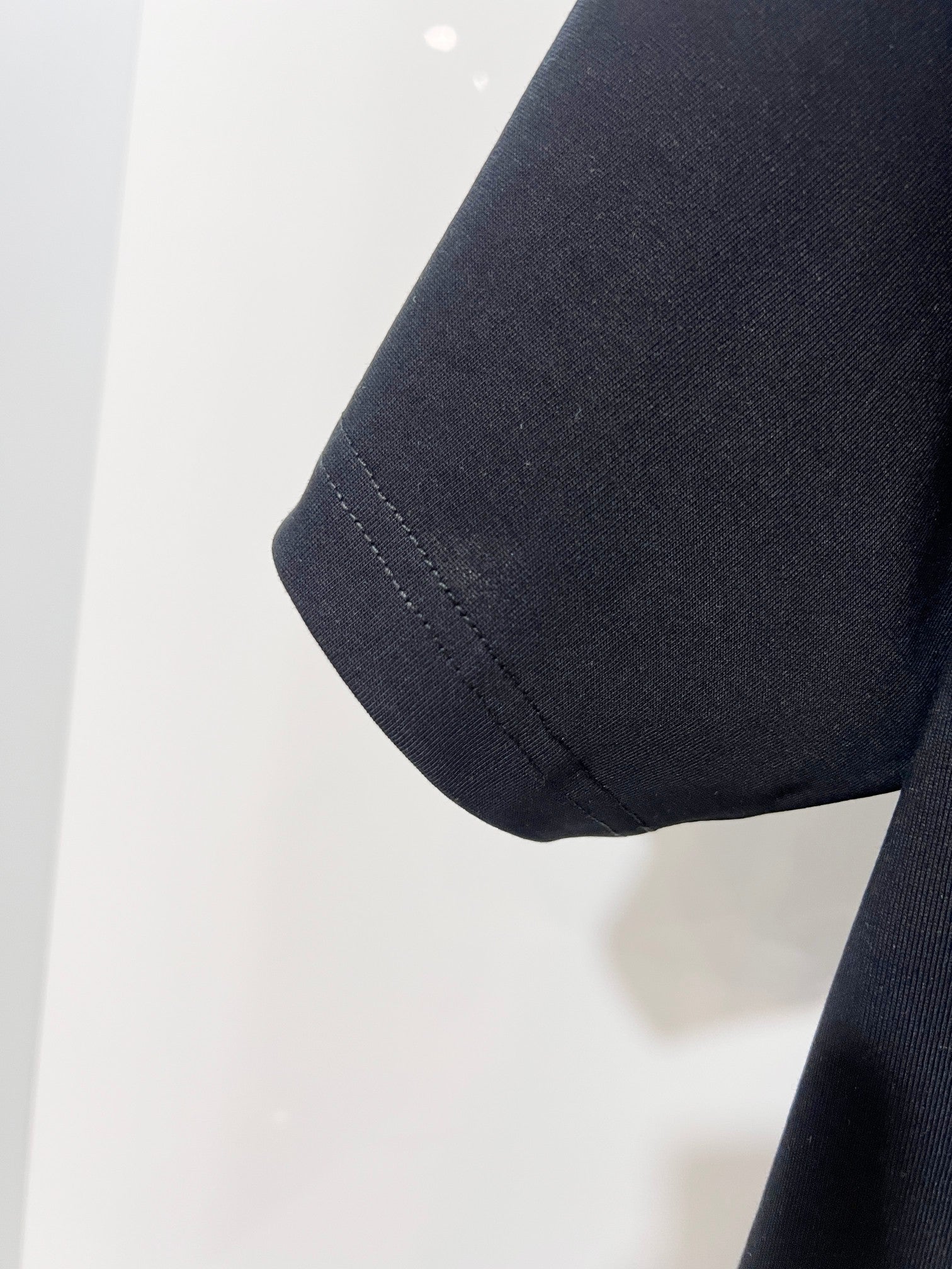 Louis Vuitton black T-shirt sleeve hem close-up