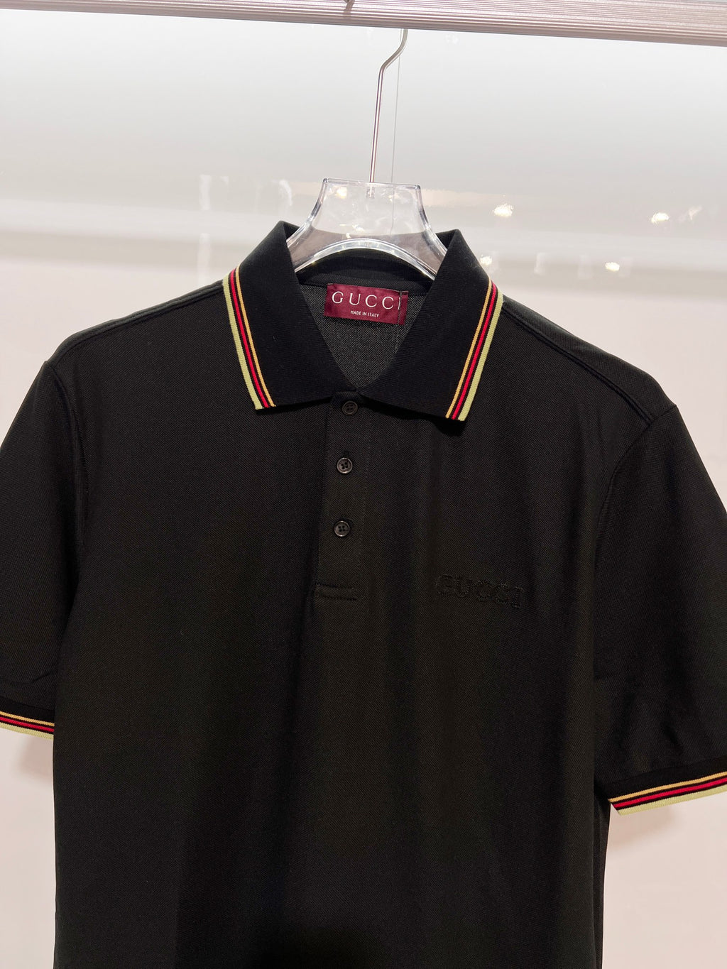 Gucci black polo shirt front view with striped collar trim