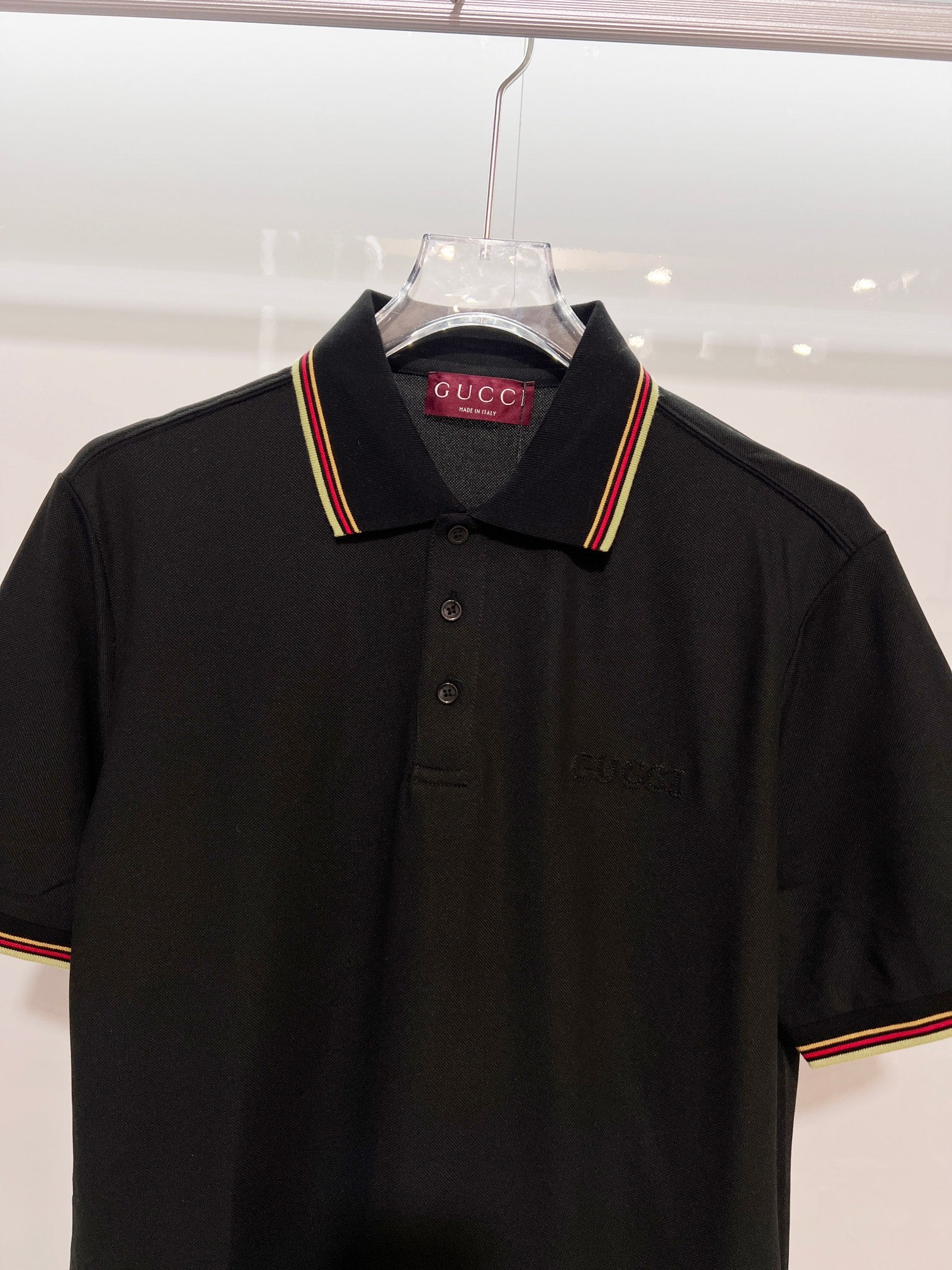Gucci black polo shirt front view with striped collar trim