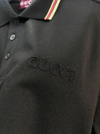 Gucci black polo shirt fabric texture with embroidered logo near chest