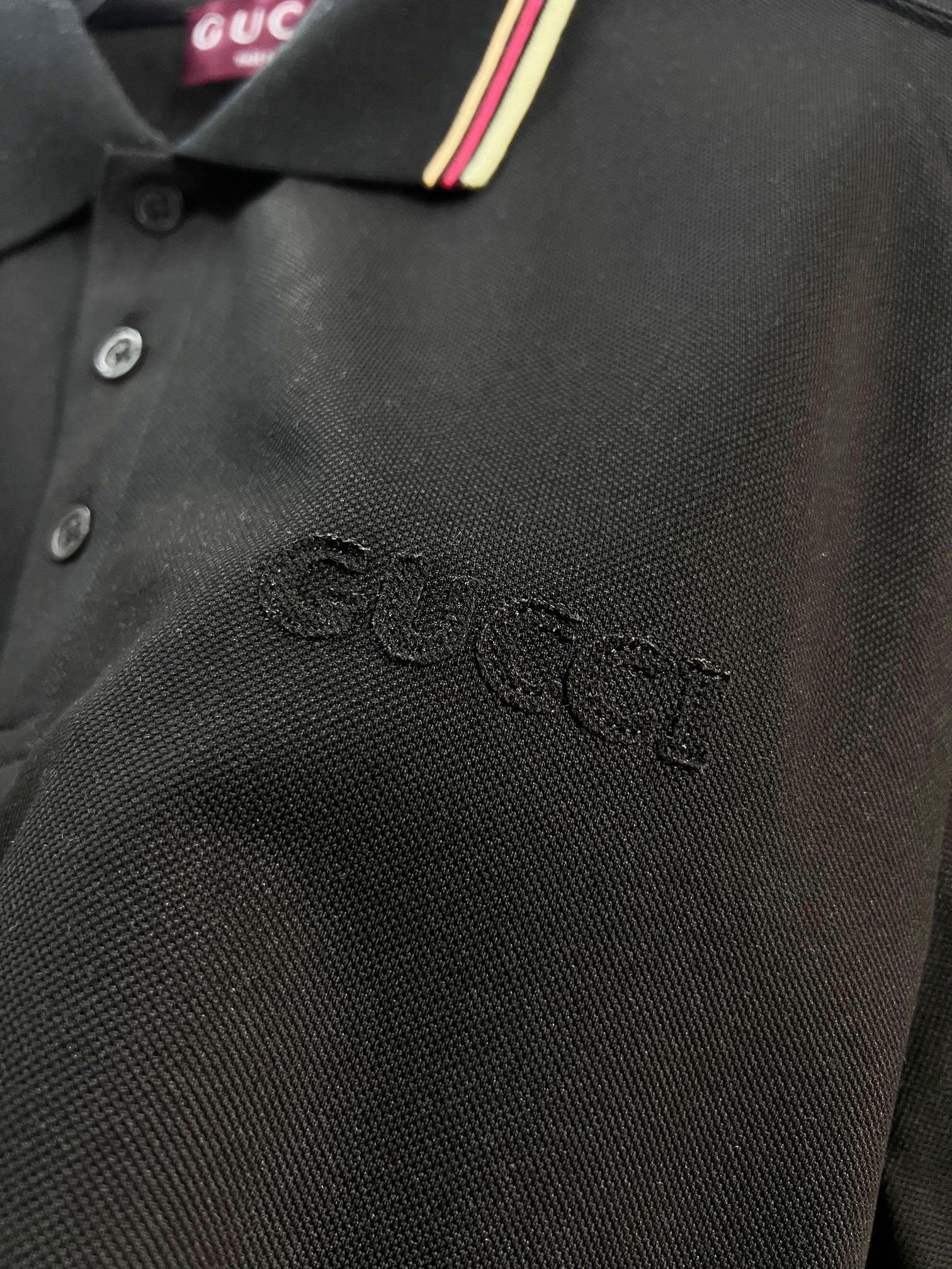 Gucci black polo shirt fabric texture with embroidered logo near chest