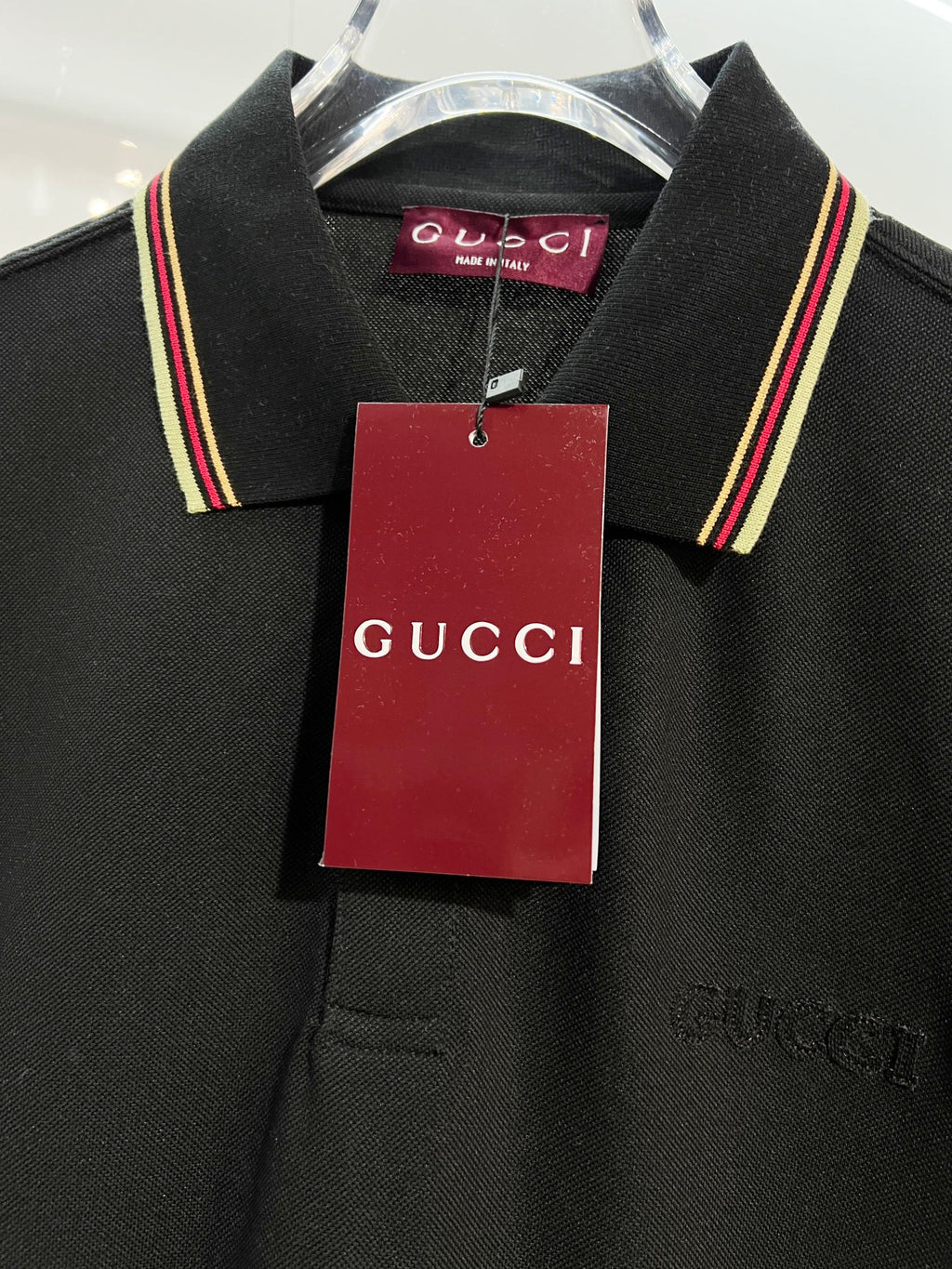 Gucci black polo shirt close-up of collar and hanging tag