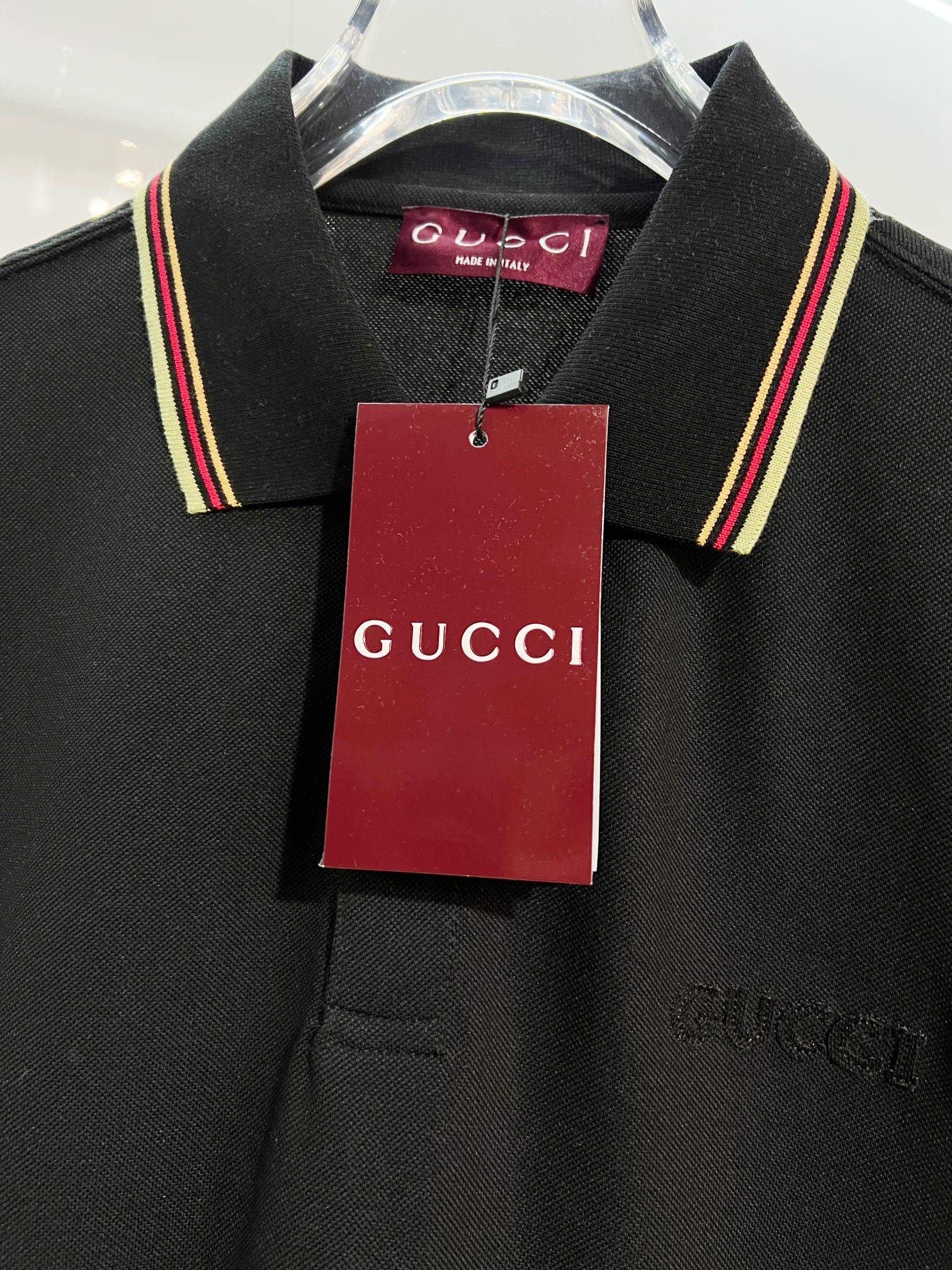 Gucci black polo shirt close-up of collar and hanging tag