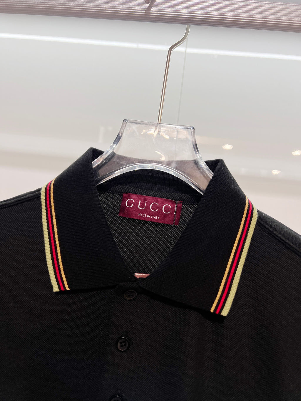 Gucci black polo shirt close-up on shoulders and striped collar