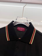 Gucci black polo shirt close-up on shoulders and striped collar