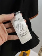 Gucci black polo shirt care label on collar area