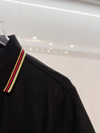 Gucci black polo shirt sleeve with striped trim at cuff
