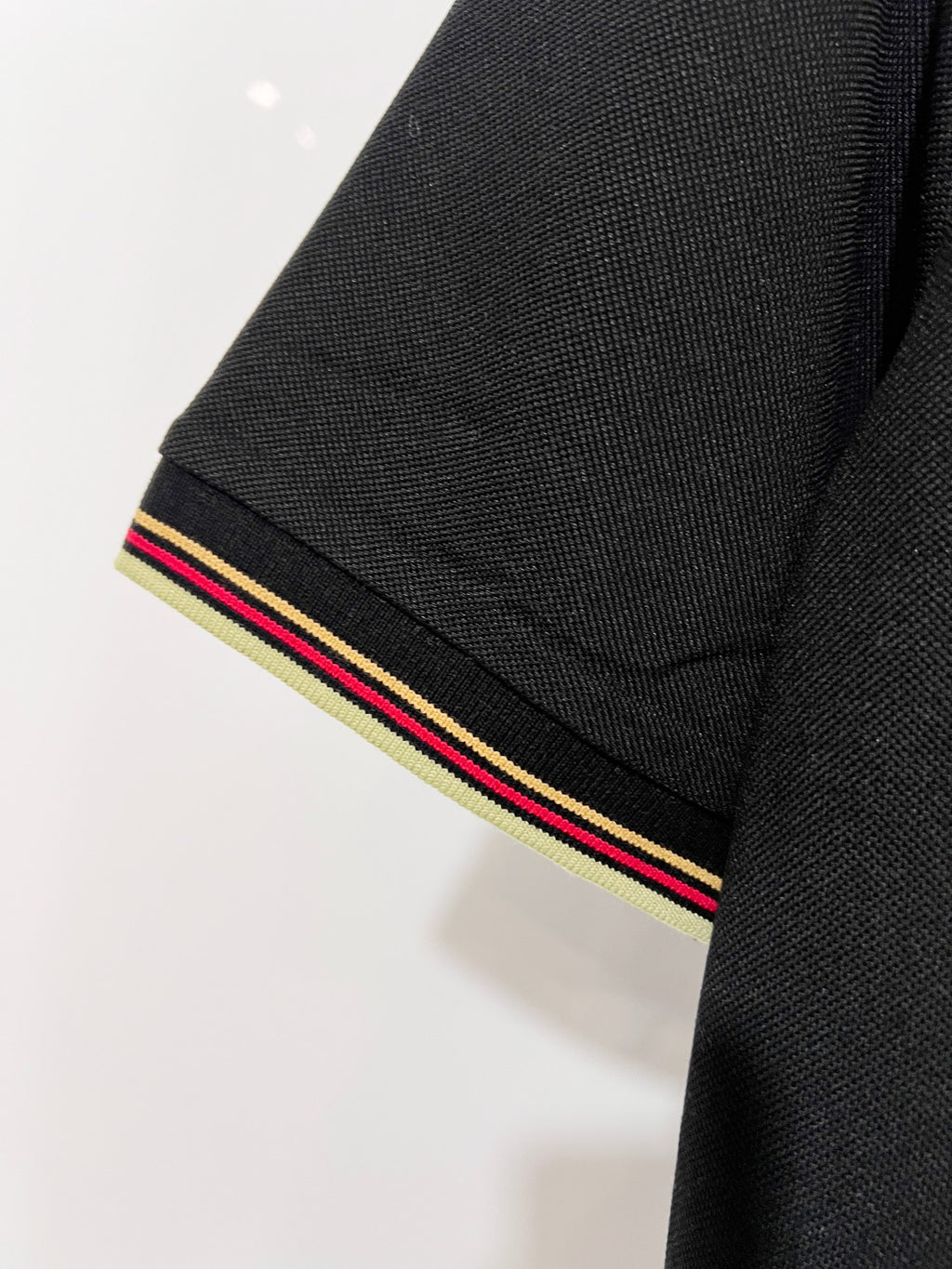 Gucci black polo shirt sleeve cuff with multicolor stripe trim