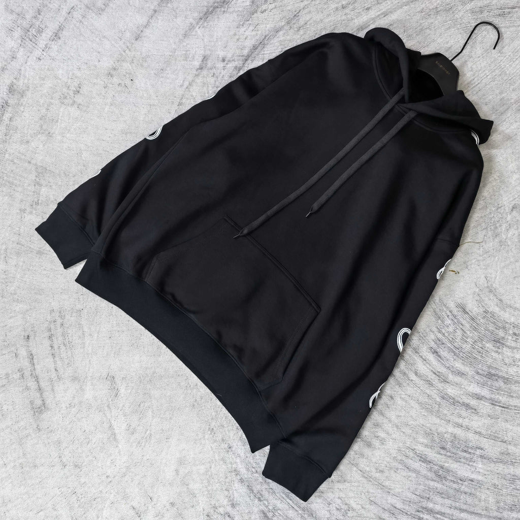 Balenciaga black hoodie laid flat with hood, drawstring, and front pocket