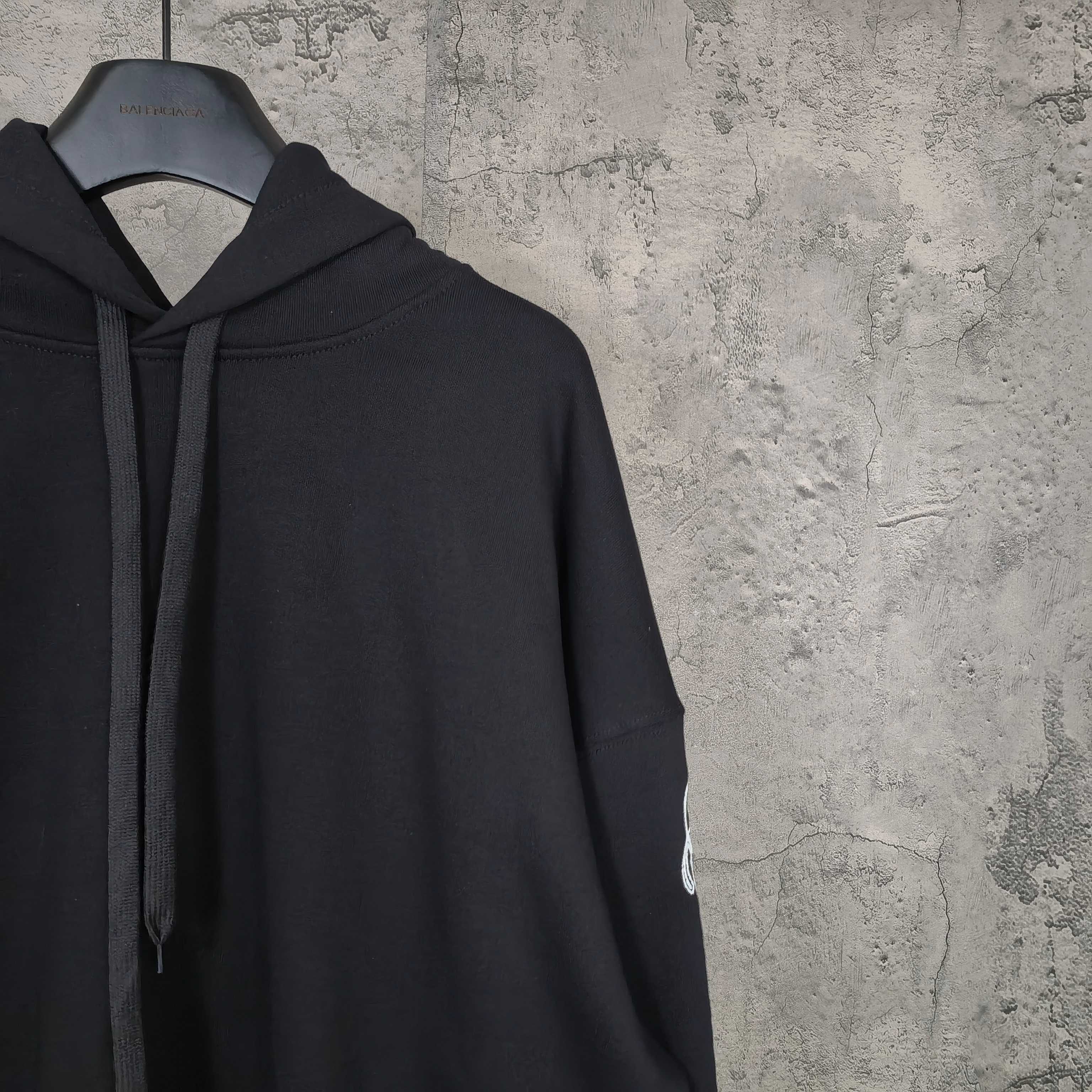 Balenciaga black hoodie side view with hood and drawstring