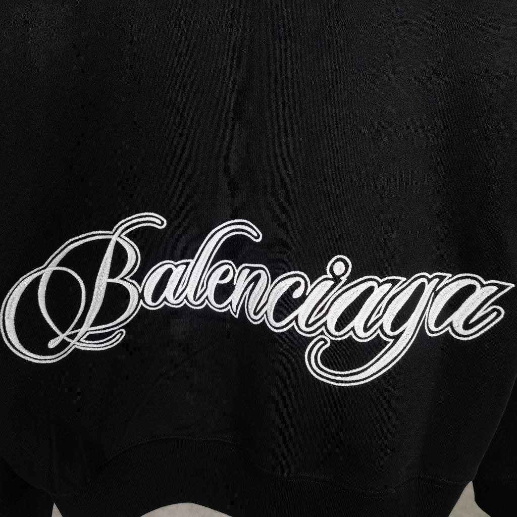 Balenciaga black hoodie close-up of script logo across the chest area