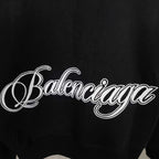 Balenciaga black hoodie close-up of script logo across the chest area
