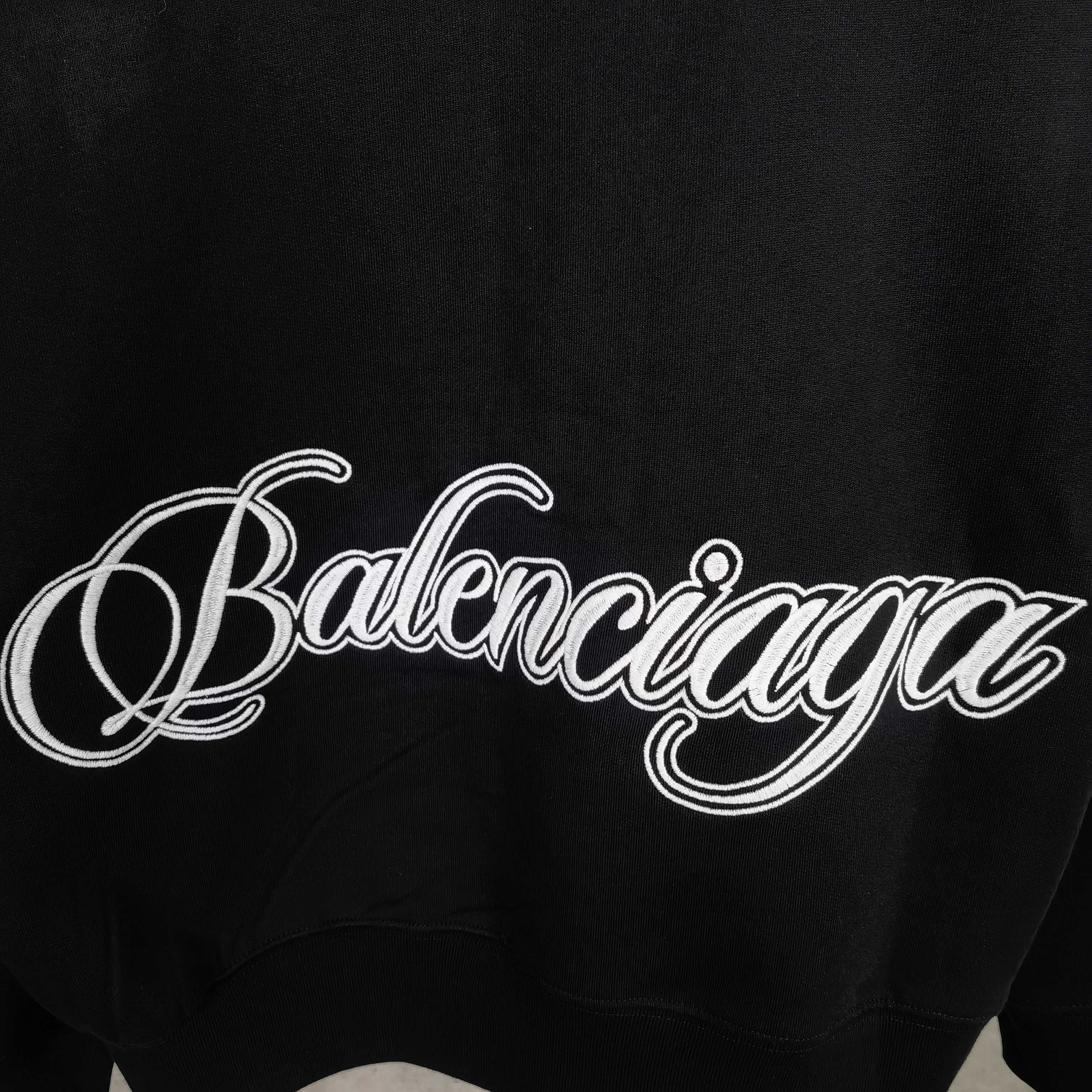 Balenciaga black hoodie close-up of script logo across the chest area