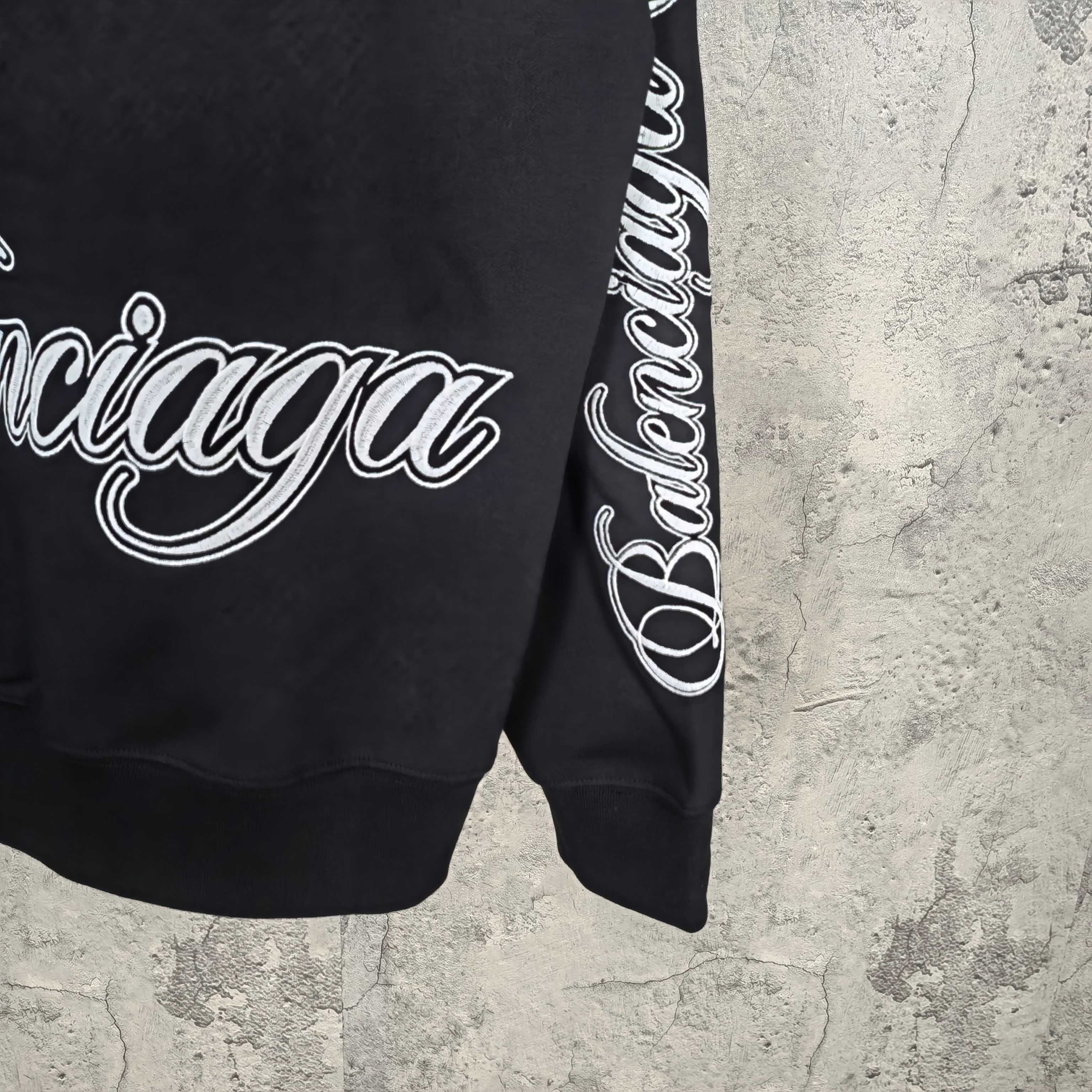 Black Balenciaga sweatshirt sleeve with white script logo