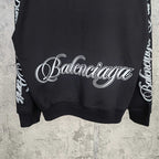 Black Balenciaga sweatshirt with large white script logo at center back