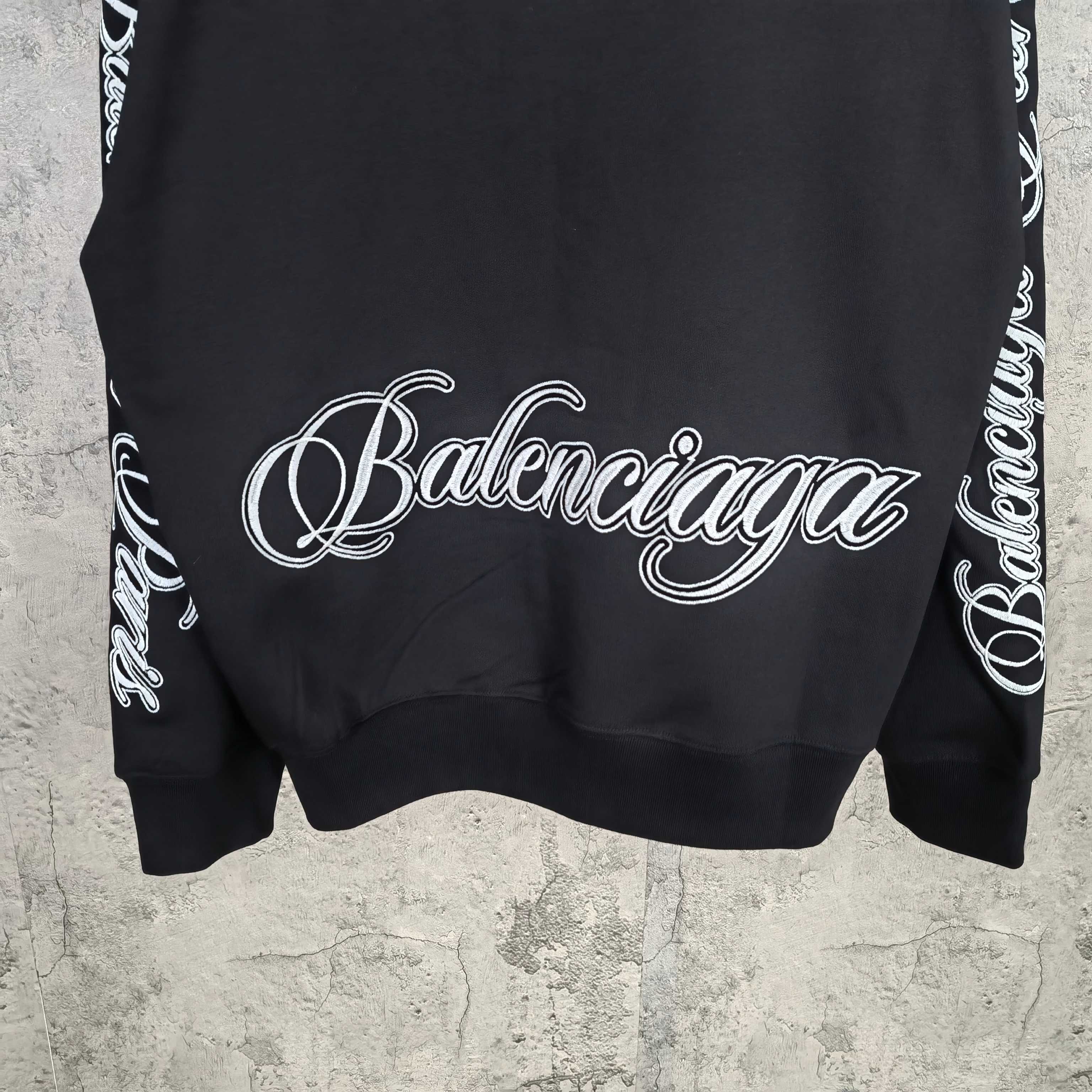 Black Balenciaga sweatshirt with large white script logo at center back