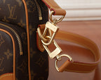 Louis Vuitton bag strap hardware with gold-tone hooks and leather loop