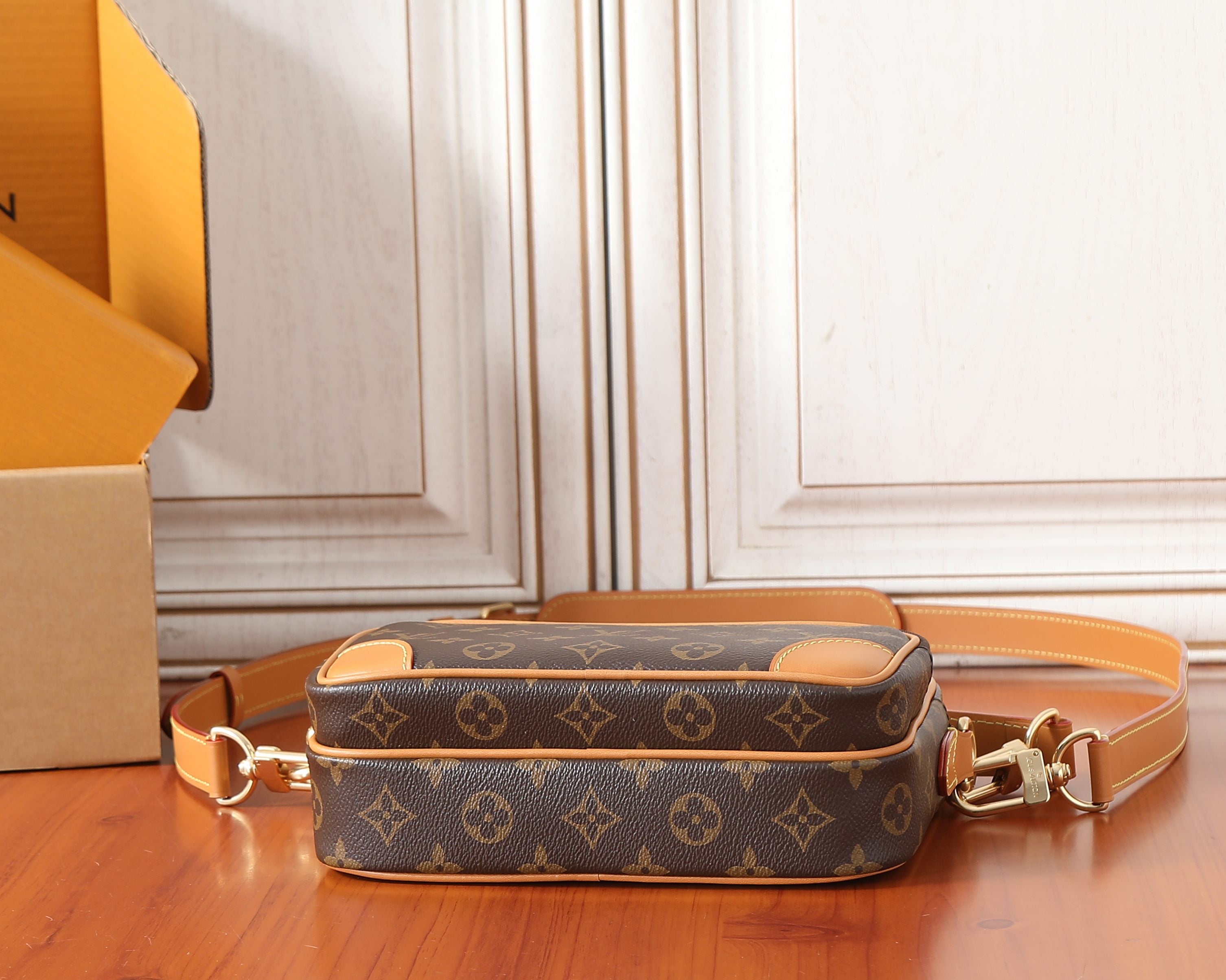 Louis Vuitton mini crossbody bag with long tan strap and brown monogram canvas