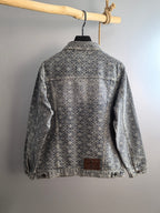 Back view of gray long-sleeve jacket with embroidered floral pattern and button closure