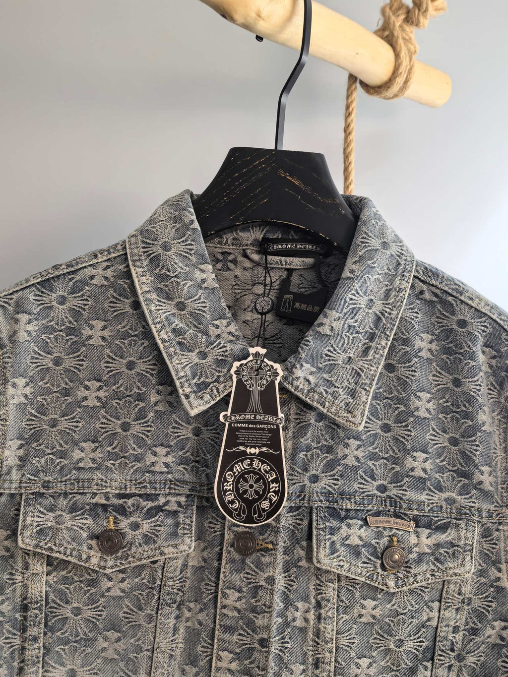 Gray jacket collar and front with floral embroidery, snap flap pockets, and hanging tag