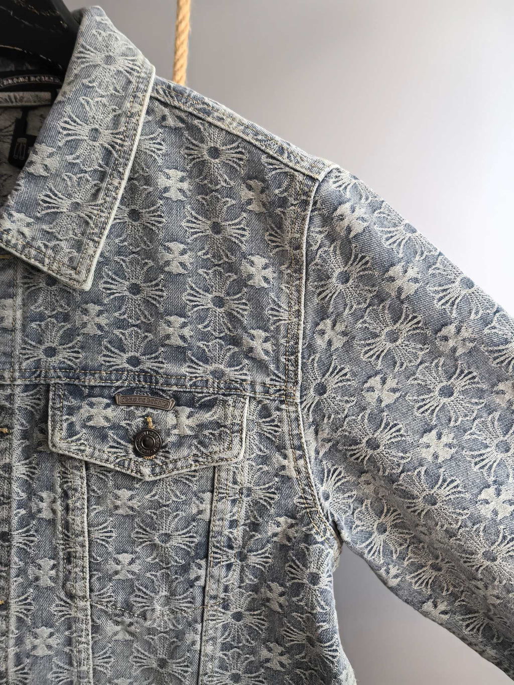 Gray embroidered jacket sleeve and front pocket with button details