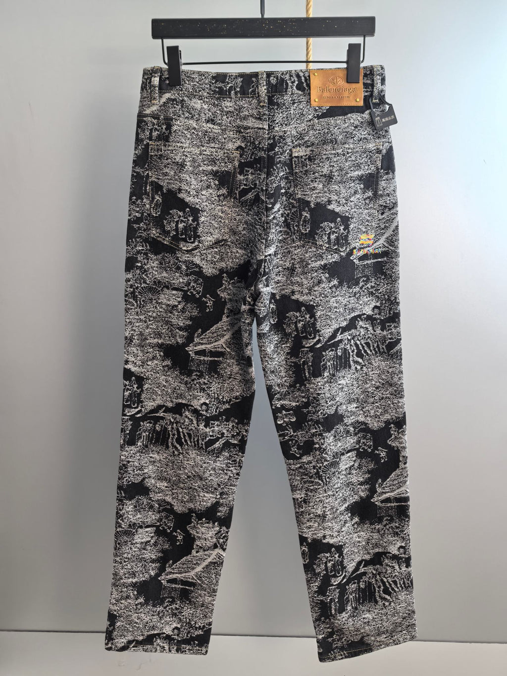 Black-and-white abstract printed long pants shown front view with belt loops