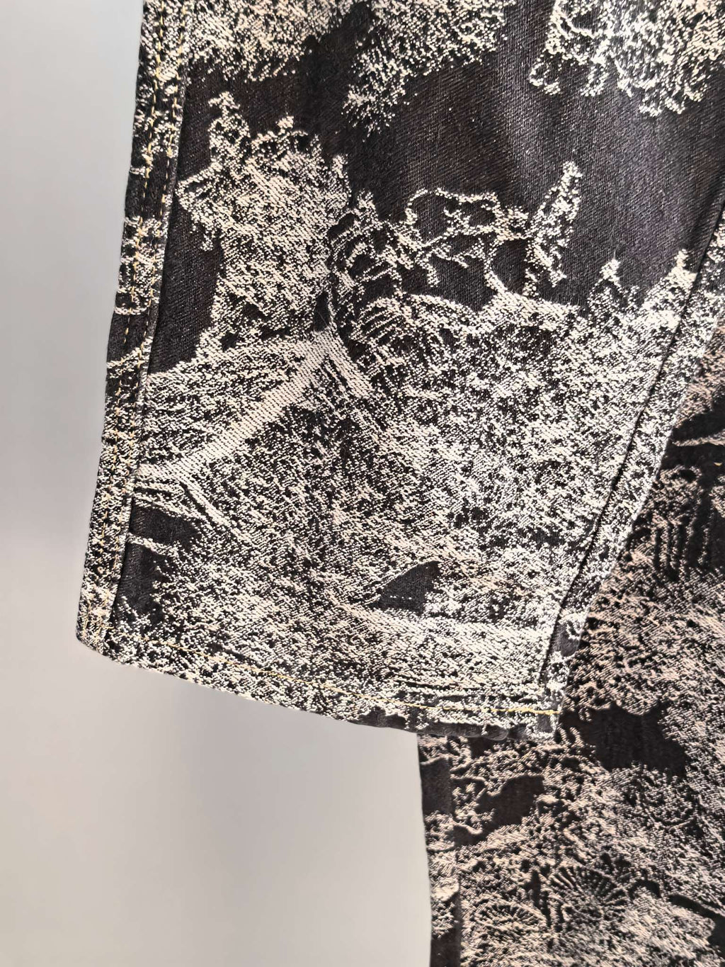 Close-up of black-and-white abstract printed fabric on long pants