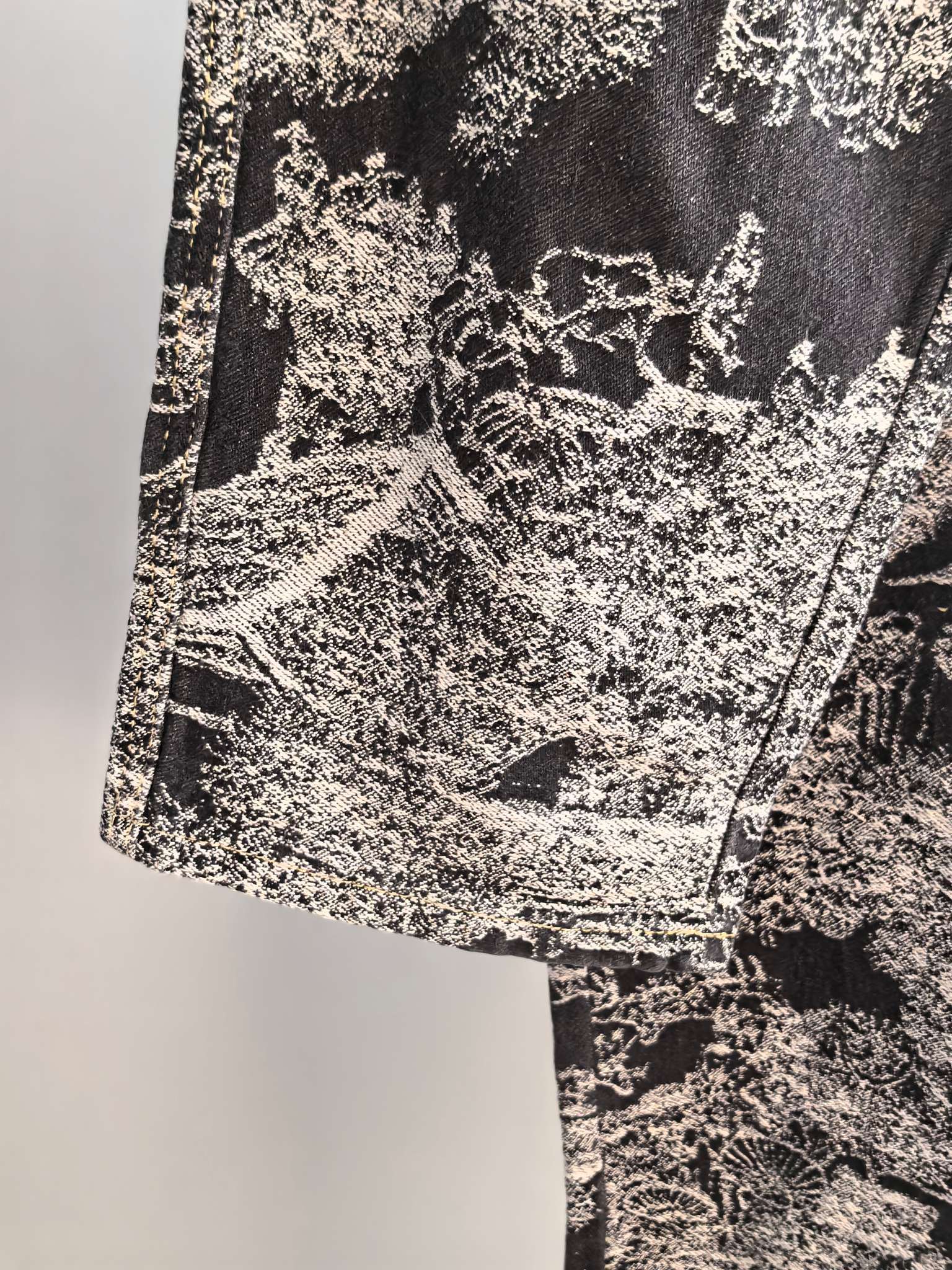Close-up of black-and-white abstract printed fabric on long pants
