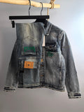 Denim jacket with button front and chest patches, light blue wash