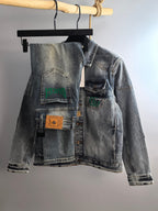 Denim jacket with button front and chest patches, light blue wash