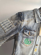 Denim jacket shoulder and front with flap pocket and logo patch, blue wash