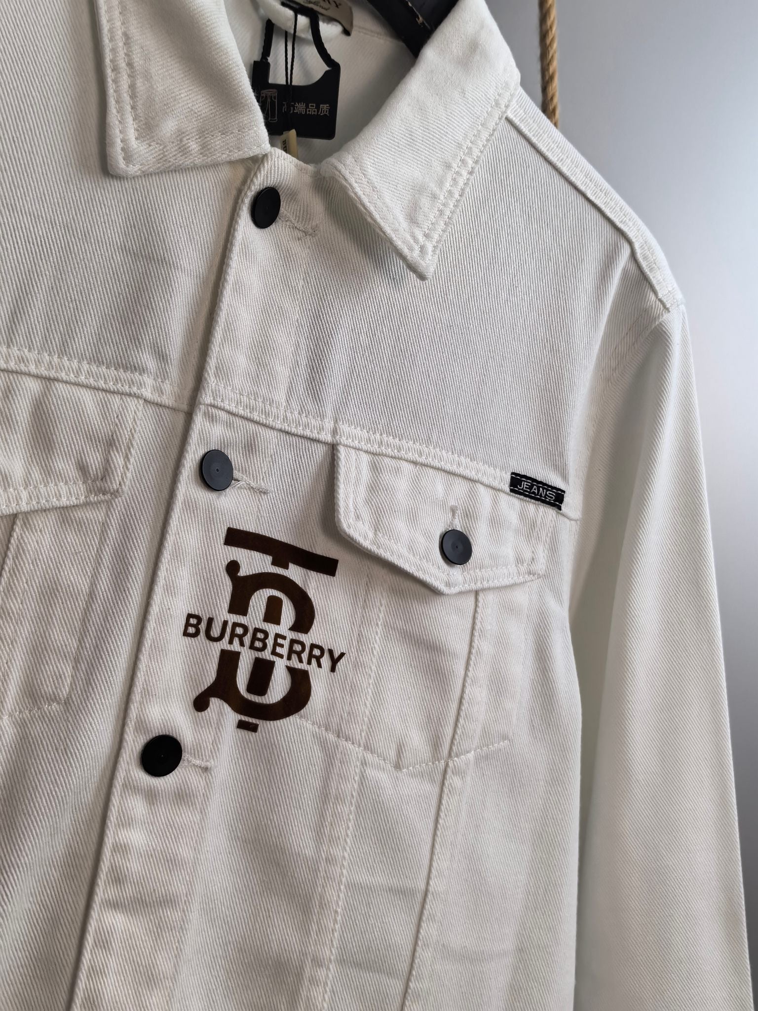 Burberry long-sleeve jacket in white with large front logo print and button placket