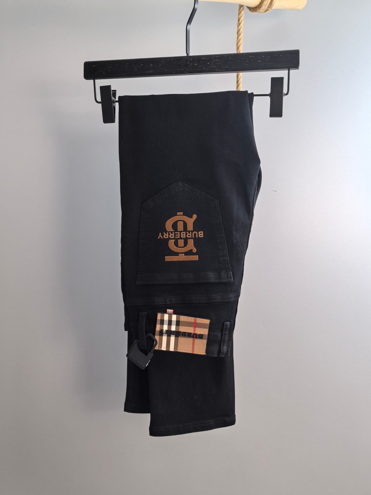 Burberry long pants, black denim with Burberry logo patch and plaid detail inside