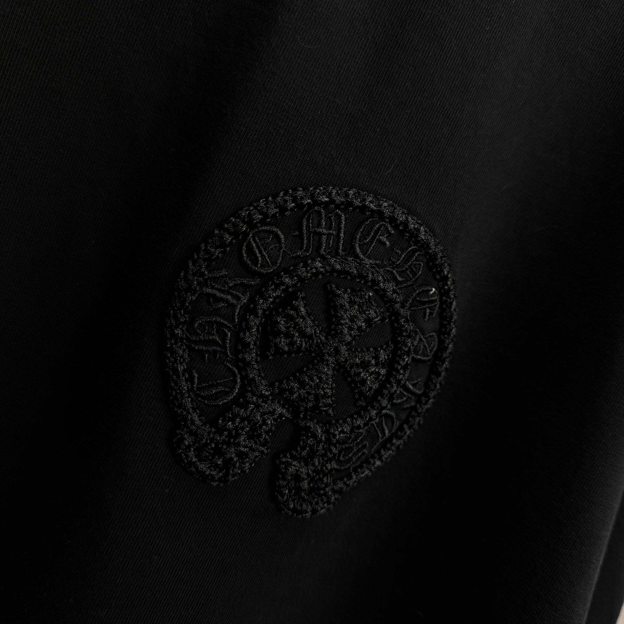 Black short-sleeve T-shirt with embossed circular crest logo