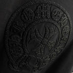 Black short-sleeve T-shirt with detailed embossed circular crest graphic