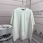 Light short-sleeve crewneck T-shirt with small circular embroidered logo on chest.