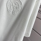 Light T-shirt fabric with partial circular embroidered logo.