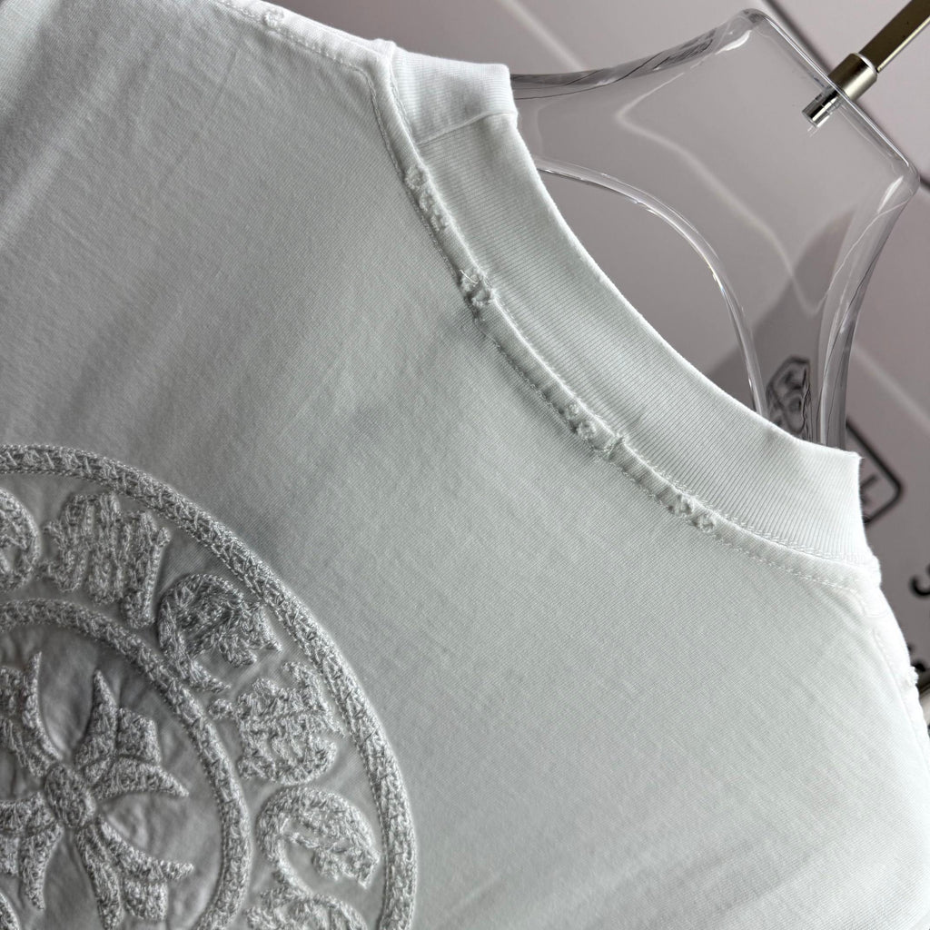 Light T-shirt neckline with partial circular embroidered crest logo.