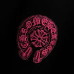 Black T-shirt with large pink embroidered circular graphic