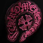 Black T-shirt with detailed pink embroidered circular emblem