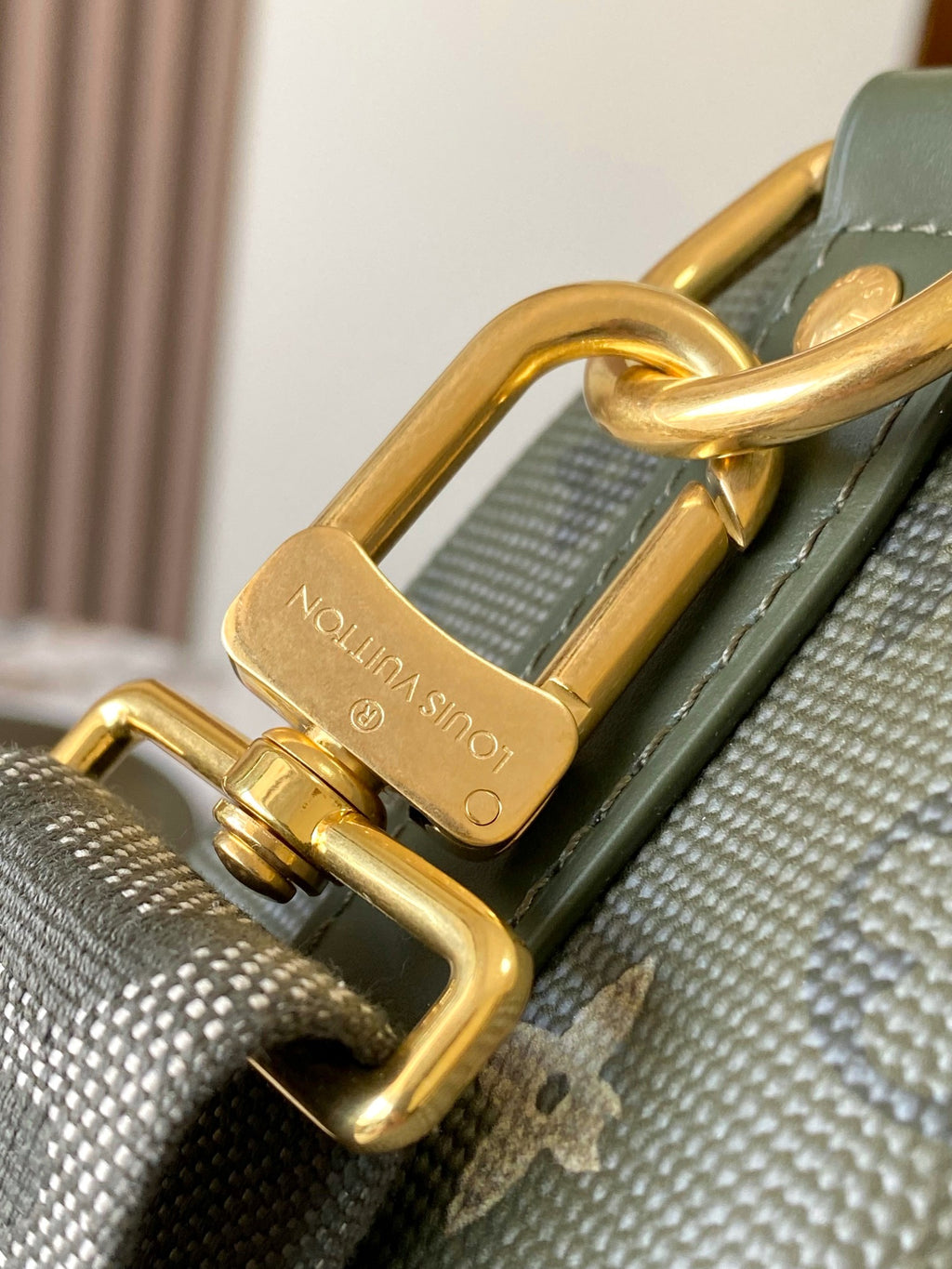 Louis Vuitton green monogram bag with gold D-ring and clasp hardware