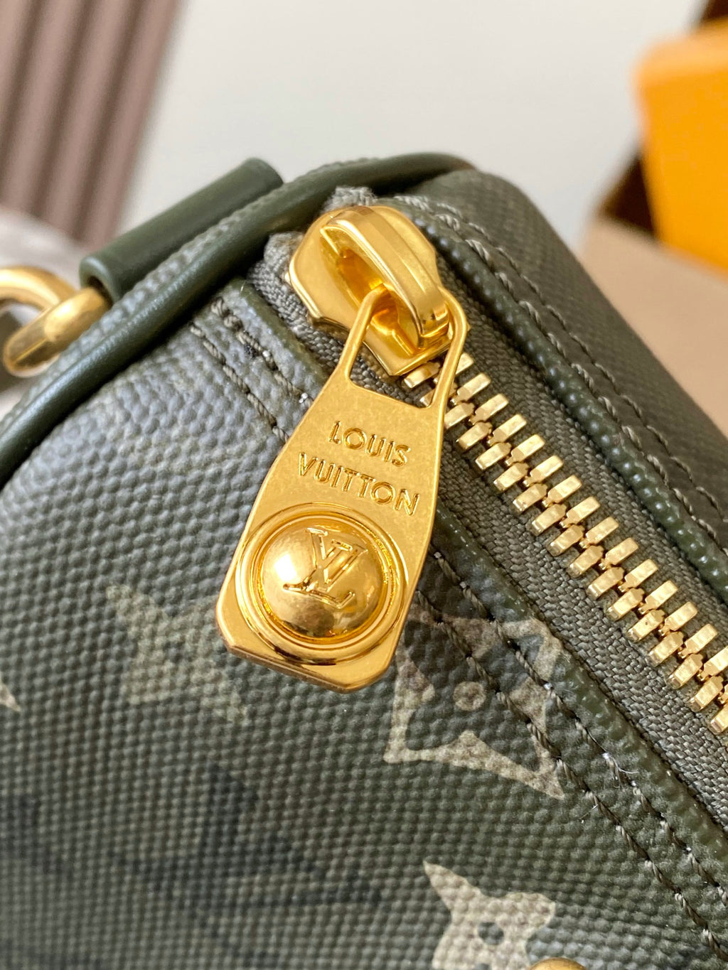 Louis Vuitton green monogram bag zipper pull with gold charm and engraved emblem