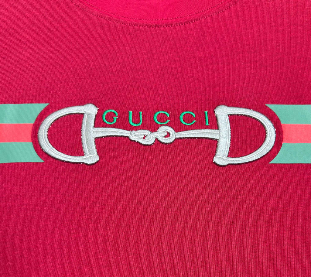 Gucci logo graphic on red T-shirt with green and pink striped band