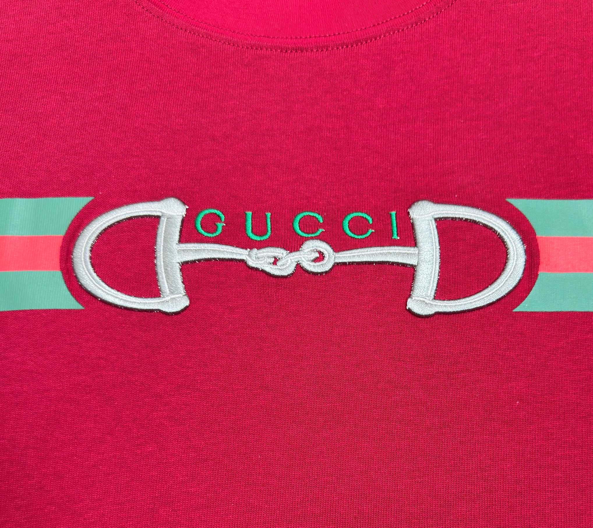 Gucci logo graphic on red T-shirt with green and pink striped band
