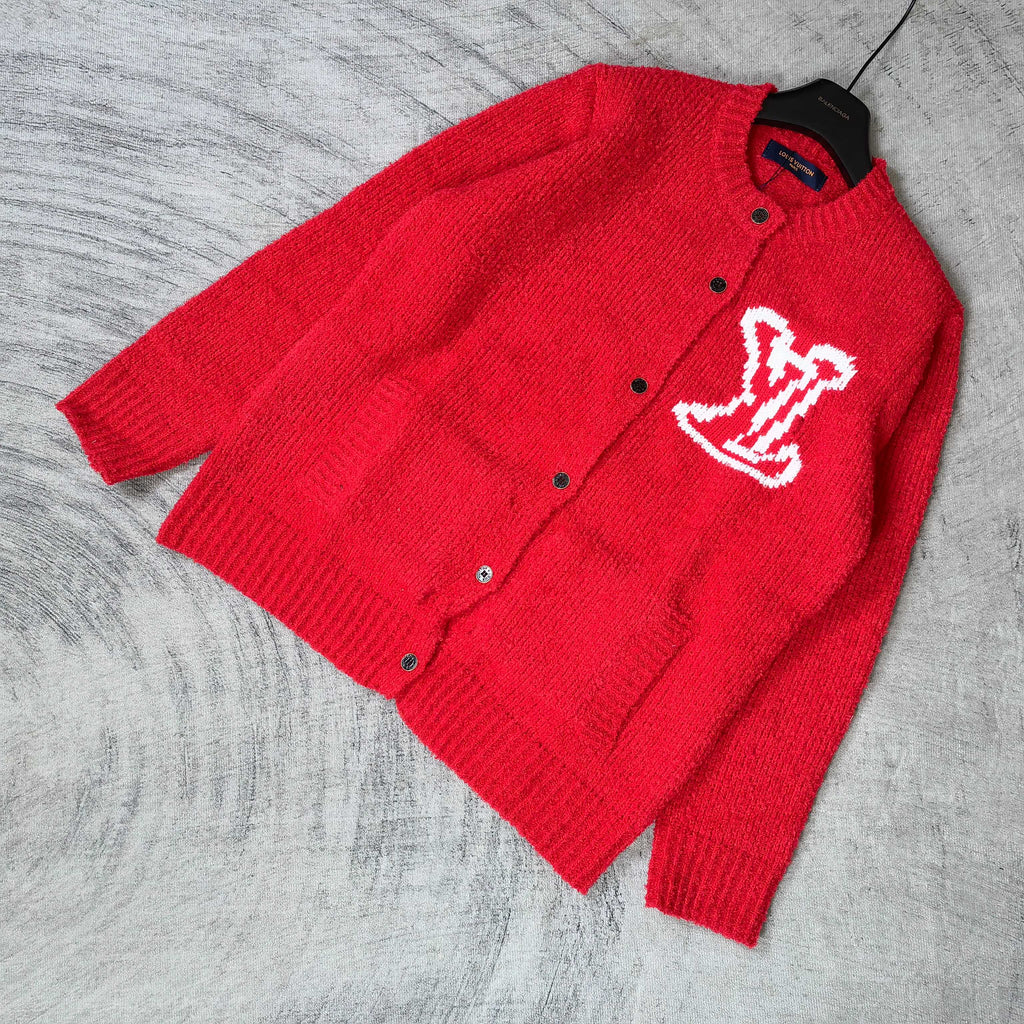 Red knit cardigan with button front and white LV monogram, laid at angle
